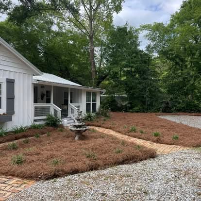 Downtown Fairhope cottage with brick walkway and refreshed pine straw