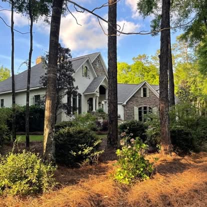 Lake house in the pines with a full pine straw install